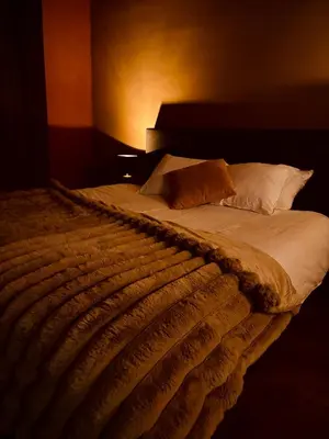 a bedroom with a large bed with white sheets and pillows at 'T Rood Kasteel in Hasselt