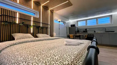 a bedroom with a large bed with towels on it at Chez Margueritte, Cosy, Jacuzzi & Parking Facile in Liège