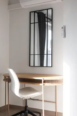 a desk with a mirror and a white chair at Moni 2D Residence in Seraing