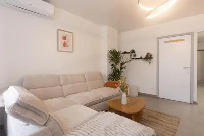 a living room with a couch and a table at Moni 2D Residence in Seraing