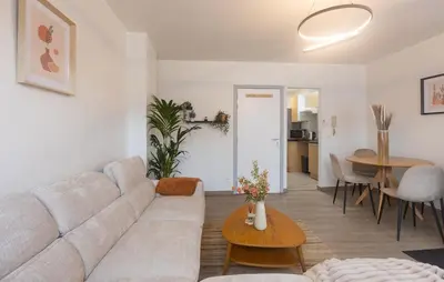 a living room with a couch and a table at Moni 2D Residence in Seraing