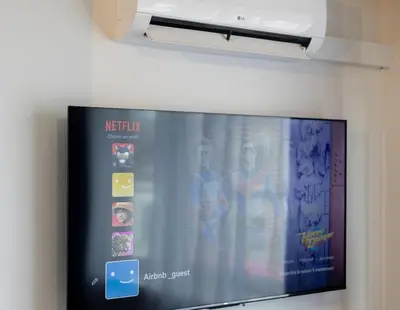 a flat screen tv hanging on a wall at Moni 2G Residence in Seraing