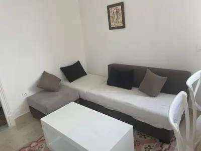 a living room with a couch and a chair at chez zakk in Seraing