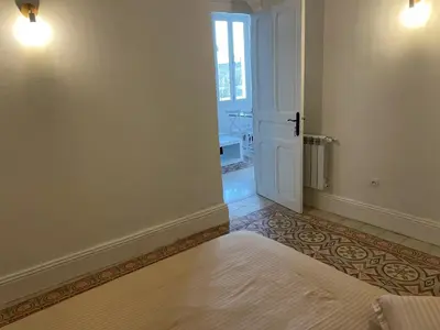 a bedroom with a bed and an open door at chez zakk in Seraing