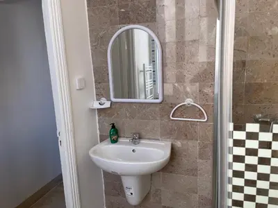 a bathroom with a sink and a mirror at chez zakk in Seraing