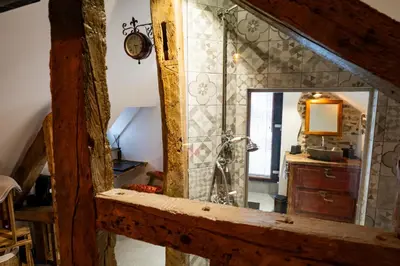 a bathroom with a shower and a mirror at les jardins de la ferme in Soumagne