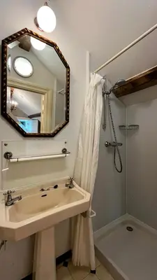 a bathroom with a sink and a mirror and a shower at Hoefke Voort - Familievakantie midden in de natuur