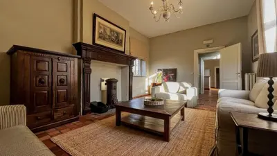 a living room with a couch and a coffee table at Hoefke Voort - Familievakantie midden in de natuur