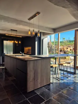 a kitchen with a large island with a counter top at Villa Marvin in Soumagne