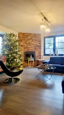a living room with a christmas tree and a blue couch at Villa Marvin in Soumagne