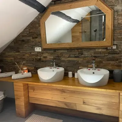 a bathroom with two sinks and a mirror at Apartment Design Suite in Jehanster