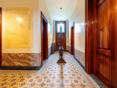 a hallway with wooden doors and a tile floor at Picturesque mansion with garden in Tongeren in Tongeren