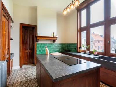 a kitchen with a counter with a laptop on it at Picturesque mansion with garden in Tongeren in Tongeren