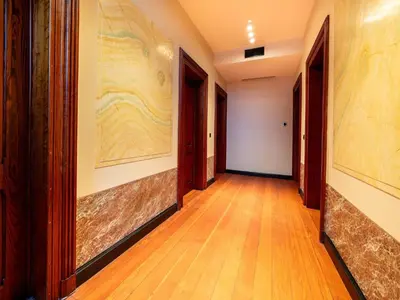 a hallway with wooden floors and paintings on the walls at Picturesque mansion with garden in Tongeren in Tongeren