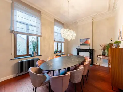 a dining room with a table and chairs at Picturesque mansion with garden in Tongeren in Tongeren