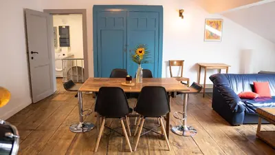 a living room with a table and chairs and a couch at Nomad Home - Bronckart 10 in Liège