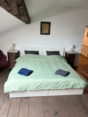 a bedroom with a bed with two blue towels on it at Nomad Home - Bronckart 10 in Liège