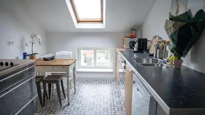 a kitchen with a sink and a counter top at Nomad Home - Bronckart 10 in Liège
