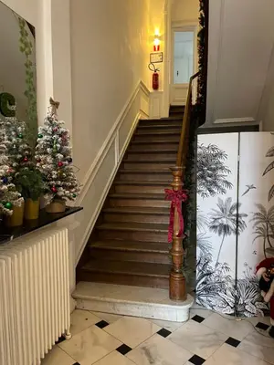 a christmas staircase with a christmas tree on the stairs at Nomad Home - Bronckart 10 in Liège