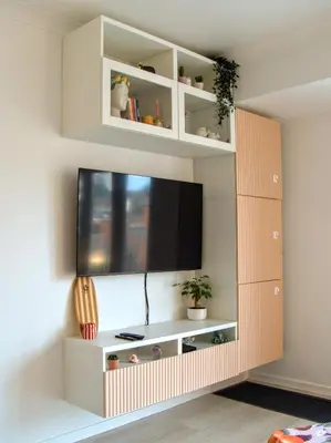 a entertainment center with a tv on a wall at Le Liégeois - Confort au Centre Ville in Liège