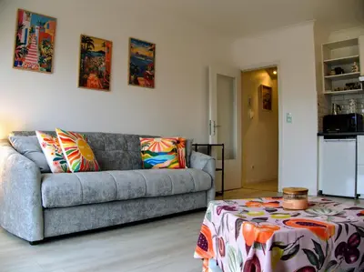 a living room with a couch and a table at Le Liégeois - Confort au Centre Ville in Liège