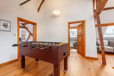 a living room with a foosball table in it at Zum Alten Kuhstall - Südgarten & Terrasse - Großes Landhaus mit Sauna in Lontzen