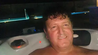 a man sitting in a bath tub at night at Villa a Chaudfontaine in Chaudfontaine