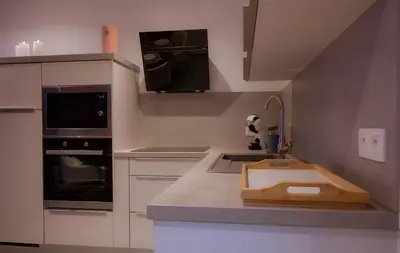 a kitchen with a counter with a sink in it at SuiteDreams - Ruby Suite Liège in Liège