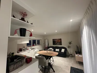 a kitchen and living room with a table and a couch at Grand Fields in Heusy