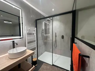 a bathroom with a glass shower and a sink at Grand Fields in Heusy
