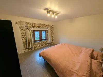 a bedroom with a bed and a window at Le Marie-Rose Charme et Pierre Porte des Fagnes in Baelen