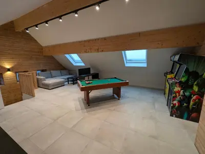 a living room with a pool table and a couch at Le Marie-Rose Charme et Pierre Porte des Fagnes in Baelen