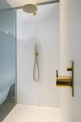 a shower with a glass door with a shower head at Villa de Fraiture in Geetbets