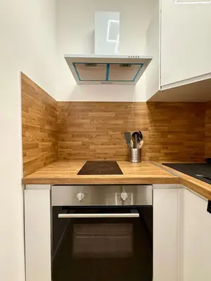 a kitchen with a stove and a counter top at Studio moderne au coeur du quartier Saint Adalbert in Liège
