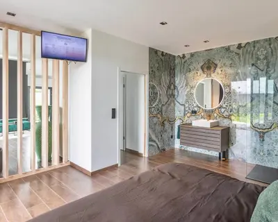 a bedroom with a large bed and a mirror at Nomad Village in Verviers