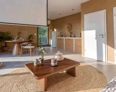 a living room with a table and a kitchen at Nomad Village in Verviers