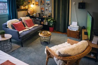 a living room with a couch and a chair at Studio by Seniko in Liège