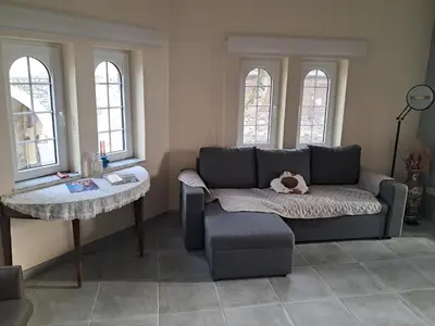 a living room with a couch and a table at Domus moerenpoort in Tongeren
