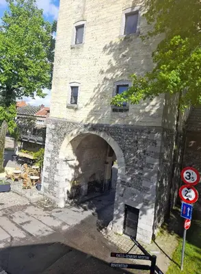 a stone building with an archway in front of it at Domus moerenpoort in Tongeren