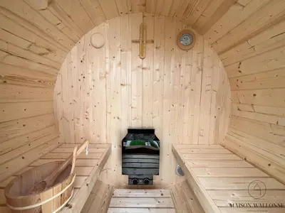 a wooden sauna with a bench in the middle at La parenthèse céleste - 2 chambres & Sauna in Liège