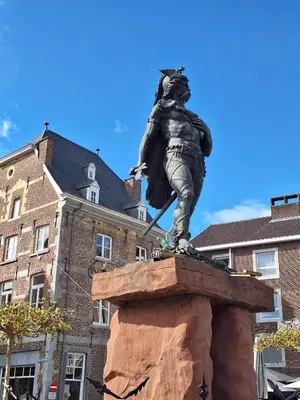 a statue of a man standing on a rock at Villa Bonifica in Riemst