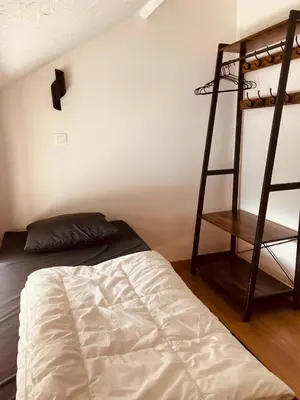 a bedroom with a bunk bed and a ladder at De Molenhoeve Gezinswoning in Voeren