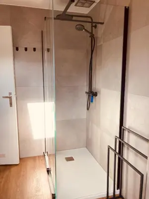 a shower with a glass door in a bathroom at De Molenhoeve Gezinswoning in Voeren