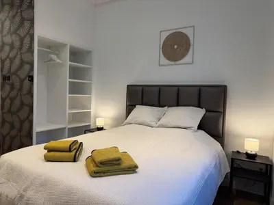 a bedroom with a bed with two towels on it at Suite Luxueuse avec jaccuzi sans vis-à-vis in Liège
