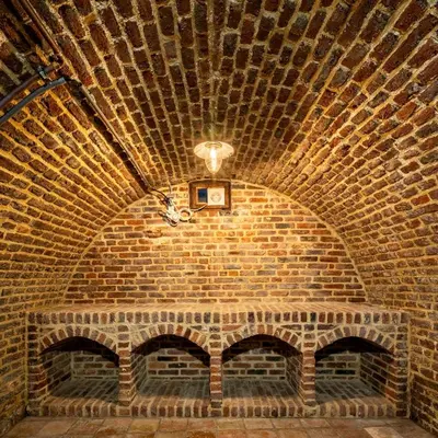 a brick room with a light on a brick wall at Vakantiewoning Begijnhof 54 in Sint-Truiden