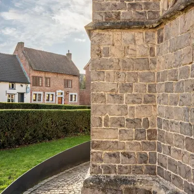 a view of a brick wall with houses in the background at Vakantiewoning Begijnhof 54 in Sint-Truiden