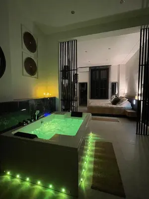 a bathroom with a jacuzzi tub in a room at Charnel - Bora Bora in Liège