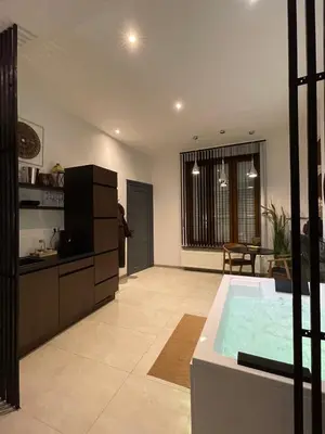 a kitchen and a living room with a hot tub at Charnel - Bora Bora in Liège
