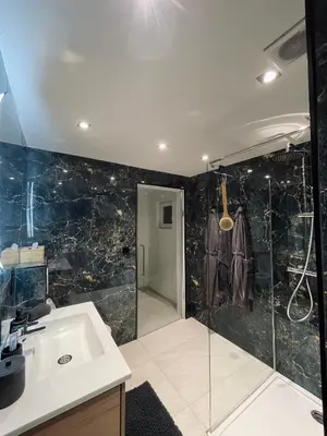 a bathroom with a sink and a shower at Charnel - Bora Bora in Liège