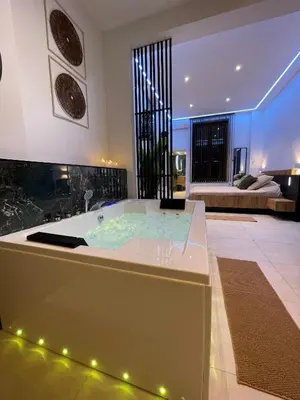 a jacuzzi tub in the middle of a room at Charnel - Bora Bora in Liège